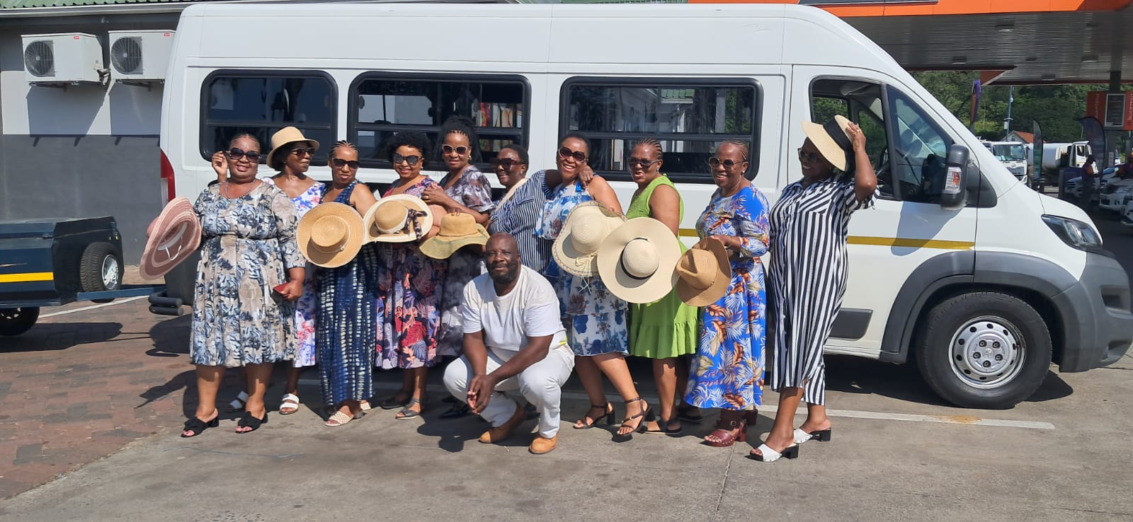 Happy tour group with Snaye van ready to depart
